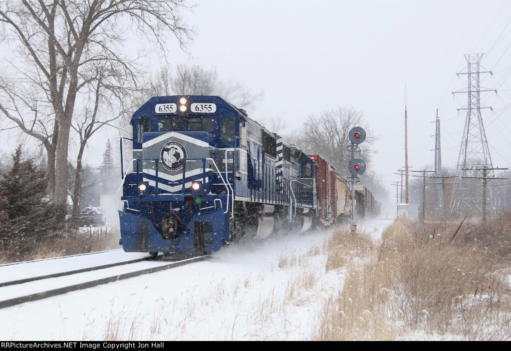 Nearing their destination, 6355 & 6303 roll down the main